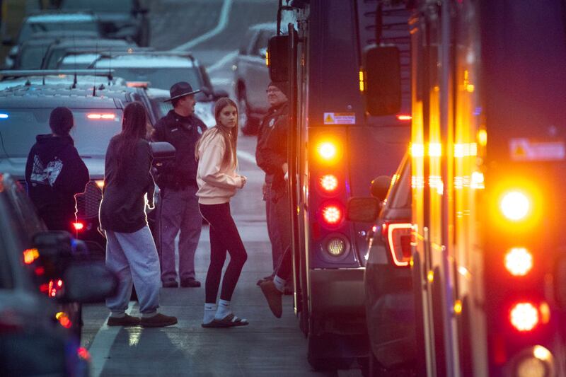 Students evacuate a church building near the site of a school shooting in Madison, Wisconsin.