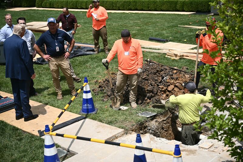 US President Donald Trump speaks with a labor crew working in the Rose Garden of the White House on June 9, 2025.
