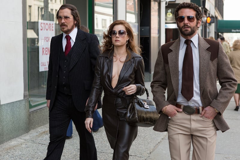 articles/2013/12/10/american-hustle-a-sexy-gleefully-chaotic-caper-starring-christian-bale-and-jennifer-lawrence/131209-stern-hustle2-tease_cf4nmk