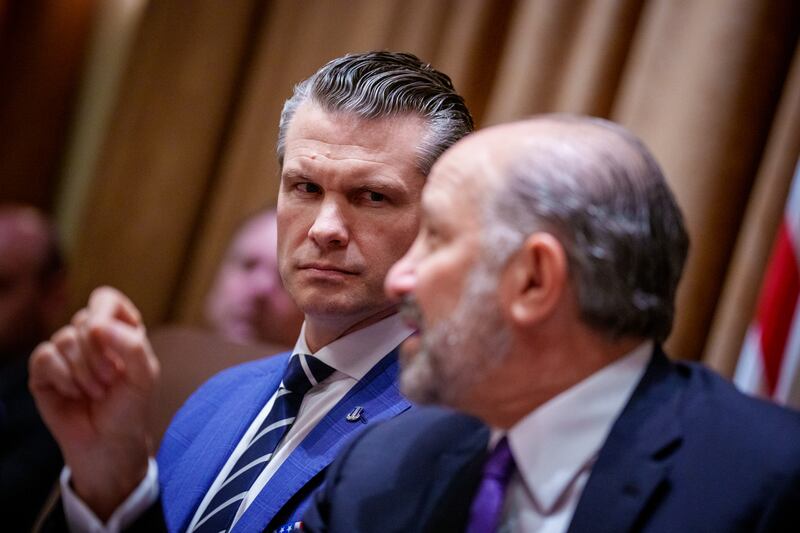 U.S. Defense Secretary Pete Hegseth (L) listens as U.S. Commerce Secretary Howard Lutnick speaks during a Cabinet meeting at the White House on February 26, 2025 in Washington, DC.