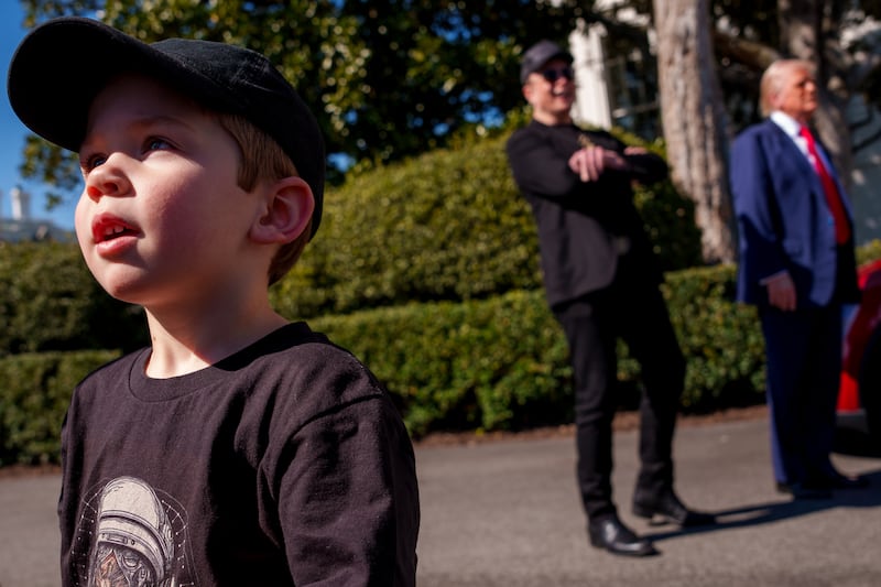 WASHINGTON, DC - MARCH 11: X Æ A-Xii, the son of White House Senior Advisor, Tesla and SpaceX CEO Elon Musk, walks across the driveway as Musk and U.S. President Donald Trump speak alongside a Tesla Model Y on the South Lawn of the White House on March 11, 2025 in Washington, DC.