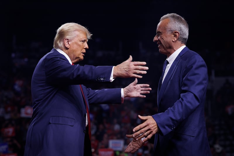 Donald Trump is greeted by Robert F. Kennedy Jr.