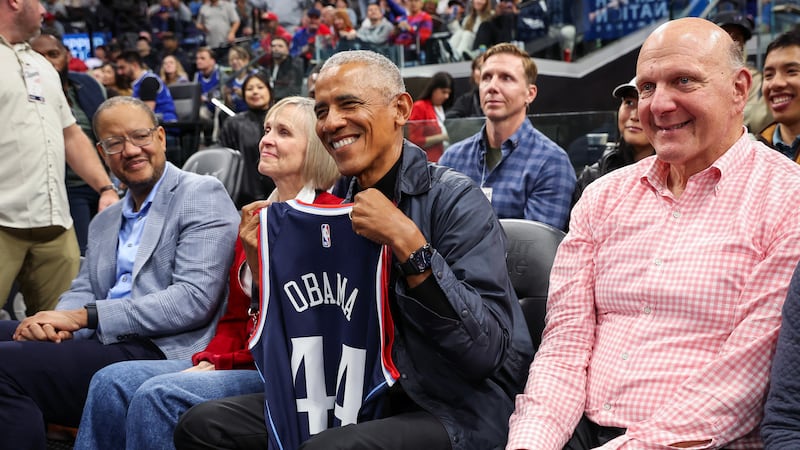 Former President Barack Obama is presented a jersey during the game between the LA Clippers and the Detroit Pistons.