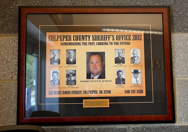 A frame displays a portrait of Culpeper County Sheriff Scott Jenkins at the Sheriff's Office in Culpeper, Virginia, a Second Amendment sancuary some 75 miles (120 kilometers) from Washington, DC on January 16, 2020. - When Sheriff Scott Jenkins swore to protect the US Constitution, he swore to uphold the second amendment -- and that means guaranteeing citizens the right to bear arms, even as the Virginia government weighs depriving state residents of what Jenkins considers an inalienable right.
"The Constitution is very clear: the second amendment grants every citizen to bear arms, specifically against a tyrannical government," said the officer from Culpeper County, a rural region about 60 miles (100 kilometers) southwest of Washington.
Since December, he has become a key figure in a pro-second amendment protest movement that has organized a protest in Richmond, the state capital, on January 20, 2020. At least 10,000 supporters plan on attending, according to media reports.
The second amendment, which says that "the right of the people to keep and bear Arms, shall not be infringed," has proved controversial over the years and has been subject to many different interpretations. The Supreme Court has ruled that individuals have the right to keep firearms in their households, but left it to states to determine how the weapons could be transported. (Photo by EVA HAMBACH / AFP) (Photo by EVA HAMBACH/AFP via Getty Images)
