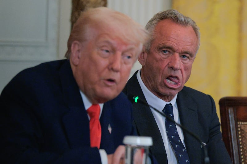 President Donald Trump (Left) and Health and Human Services Secretary Robert F. Kennedy Jr. attend an event introducing a new Make America Healthy Again Commission report in the East Room of the White House