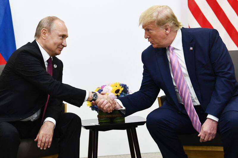 Donald Trump attends a meeting with Russia's President Vladimir Putin.