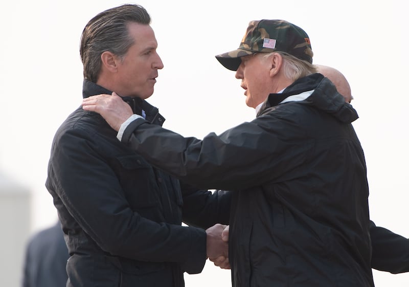 President-elect Donald Trump greets California Governor Gavin Newsom as he disembarks from Air Force One at Beale Air Force Base in California, November 17, 2018.