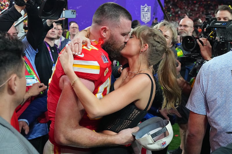Football: Super Bowl LVIII: Kansas City Chiefs Travis Kelce (87) kisses girlfriend and singer Taylor Swift following victory vs San Francisco 49ers at Allegiant Stadium.