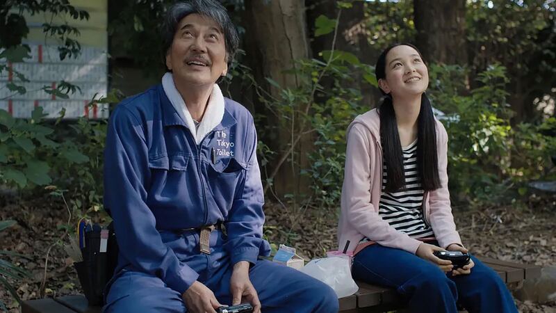 Koji Yakusho and Arisa Nakano sit next to each other in a still from 'Perfect Days'