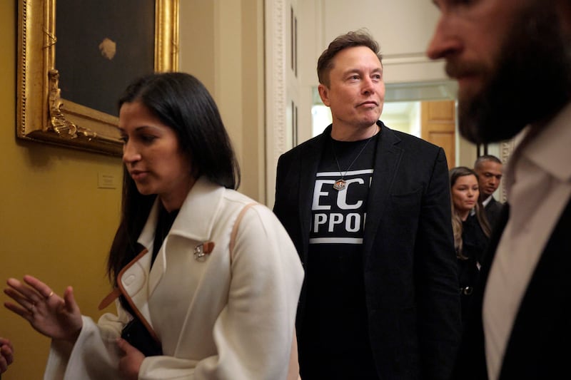 Elon Musk (C) is accompanied by Katie Miller (L) as he leaves a meeting with Senate Republicans in the U.S. Captiol on March 05, 2025 in Washington, DC.