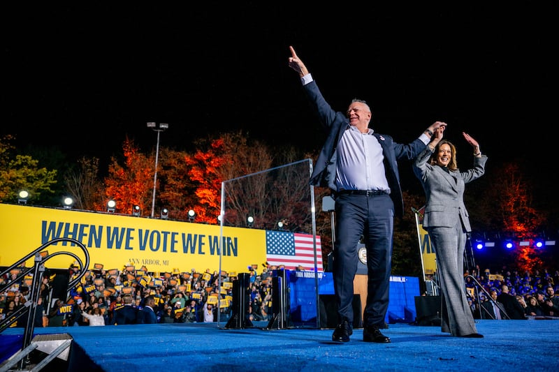 Democratic presidential nominee Kamala Harris and her running mate, Minnesota Gov. Tim Walz, greet supporters at the conclusion of a campaign rally on October 28, 2024 in Ann Arbor, Michigan.