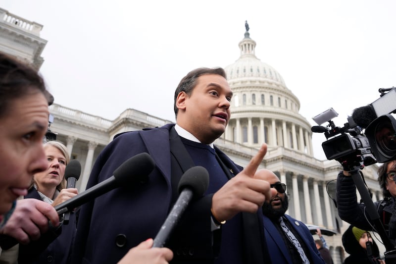 George Santos is surrounded by journalists as he leaves the U.S. Capitol after his fellow members of Congress voted to expel him from the House of Representatives on December 1, 2023 in Washington, DC.