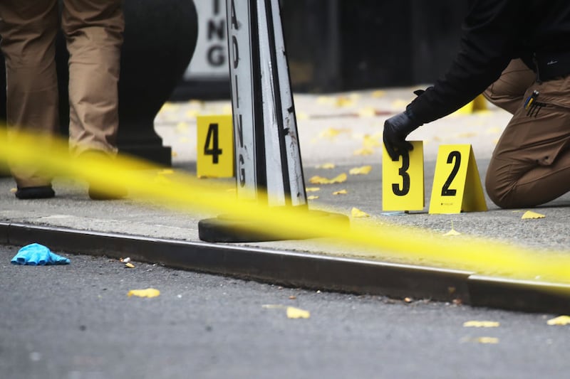 Police place bullet casing markers outside of a Hilton Hotel in Midtown Manhattan, where UnitedHealthcare CEO Brian Thompson was fatally shot last Wednesday.