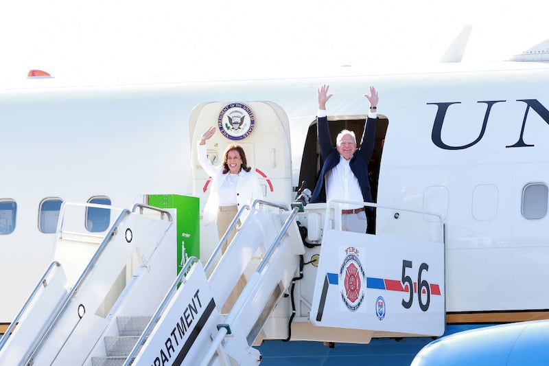 Vice President Kamala Harris and Minnesota Gov. Tim Walz arrive at the Detroit Metropolitan Airport in Romulus, Michigan.