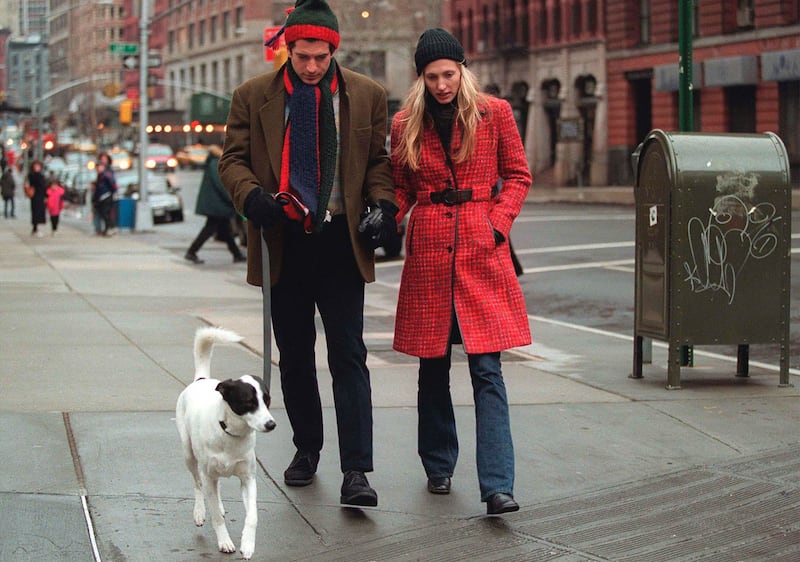 John F. Kennedy Jr. and his wife Carolyn Bessette-Kennedy walk with their dog on January 1, 1997 in New York City.