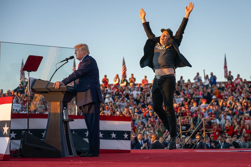 Tesla CEO Elon Musk jumps on stage as he joins former US President and Republican presidential candidate Donald Trump during a campaign rally at site of his first assassination attempt in Butler, Pennsylvania on October 5, 2024.