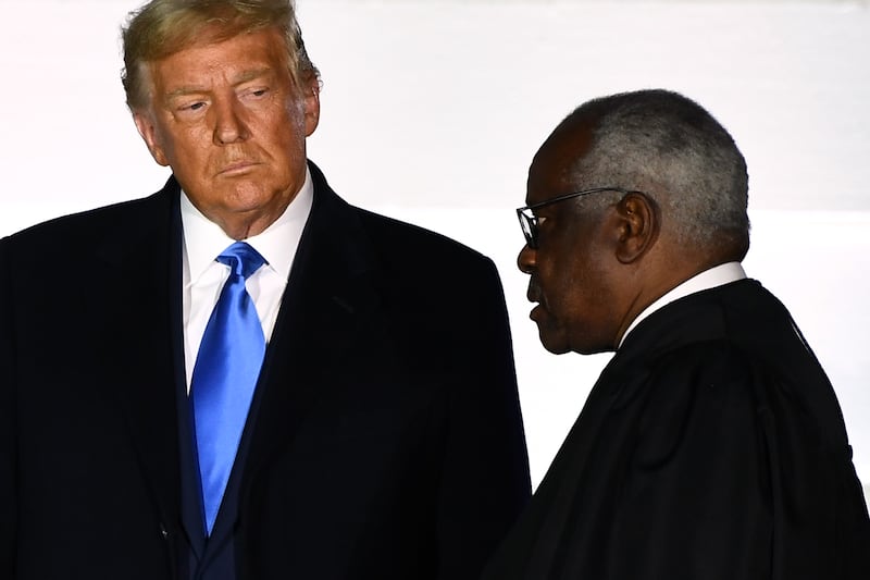 US President Donald Trump watches as Supreme Court Associate Justice Clarence Thomas swears in Judge Amy Coney Barrett (out of frame) as a US Supreme Court Associate Justice during a ceremony on the South Lawn of the White House October 26, 2020, in Washington, DC. (Photo by Brendan Smialowski / AFP) (Photo by BRENDAN SMIALOWSKI/AFP via Getty Images)