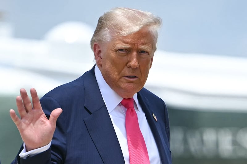 US President Donald Trump waves as he walks from Marine One to board Air Force One at Joint Base Andrews, Maryland on July 15, 2025.