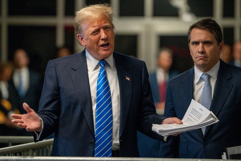 Former US President Donald Trump speaks to the press at the end of Monday’s trial proceedings.