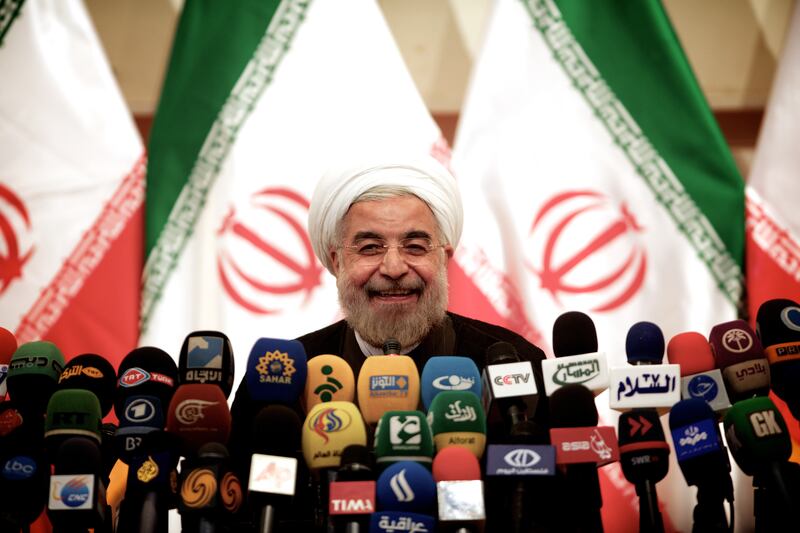 articles/2013/06/17/who-s-dismissing-the-iranian-elections/rowhani-smile-openz_kpbpz4