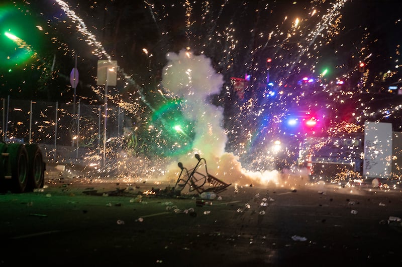 Pyrotechnics are seen as law enforcement clashes with demonstrators during a protest following federal immigration operations, in the Compton neighborhood of Los Angeles, California on June 7, 2025.