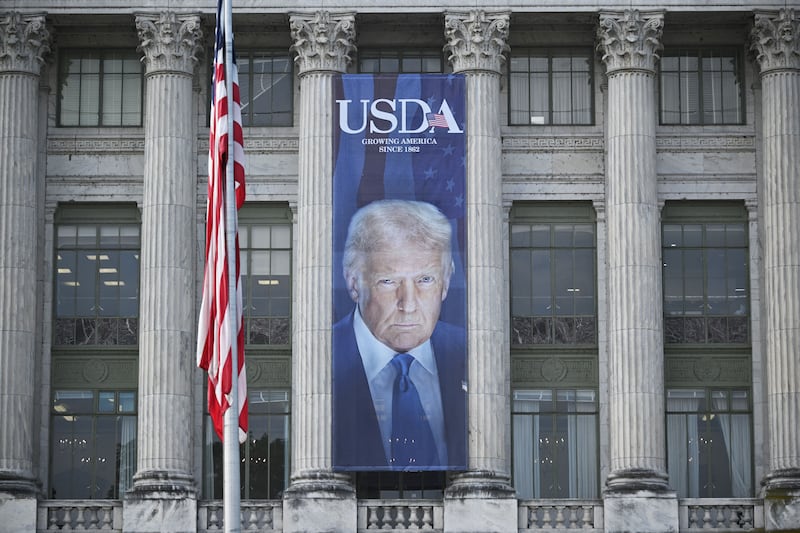 A banner showing an image of US President Donald Trump hangs on the side of a US Department of Agriculture building in Washington, DC, on May 16, 2025. The banner was put up to mark the the 163rd anniversary of the Department of Agriculture which was founded on May 15, 1862 by Abraham Lincoln. (Photo by Mandel NGAN / AFP) (Photo by MANDEL NGAN/AFP via Getty Images)