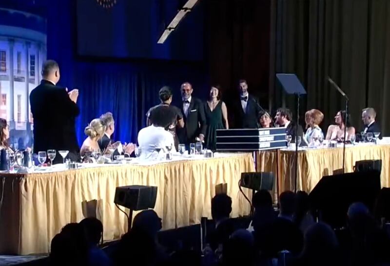 A group of people on a stage in black tie