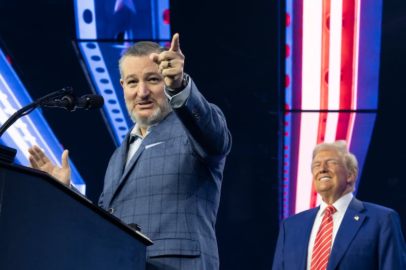 Ted Cruz speaks as U.S. President-elect Donald Trump listens during Turning Point USA's AmericaFest at the Phoenix Convention Center on December 22, 2024 in Phoenix, Arizona. The annual four day conference geared toward energizing and connecting conservative youth hosts some of the country's leading conservative politicians and activists.