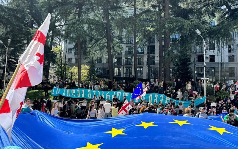 A photo of a crowd outside of the Georgian Parliament.