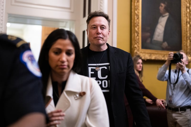 Elon Musk leaves a lunch with senate Republicans alongside Katie Miller.