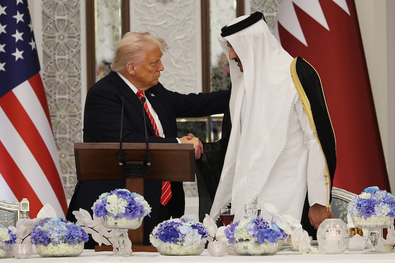 President Donald J. Trump shakes hands with Emir of Qatar Tamim bin Hamad al Thani during a state dinner at the Lusail Palace on May 14, 2025.
