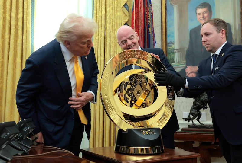 WASHINGTON, DC - MARCH 07: U.S. President Donald Trump and President of Fédération Internationale de Football Association (FIFA) Gianni Infantino unveil the 2025 Club World Cup trophy in the Oval Office at the White House on March 07, 2025 in Washington, DC. President Trump signed an executive order establishing a White House Task Force for the 2026 World Cup. (Photo by Anna Moneymaker/Getty Images)