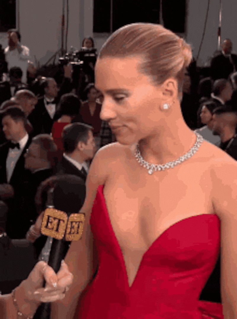 Scarlett Johanssen in red dress winking.