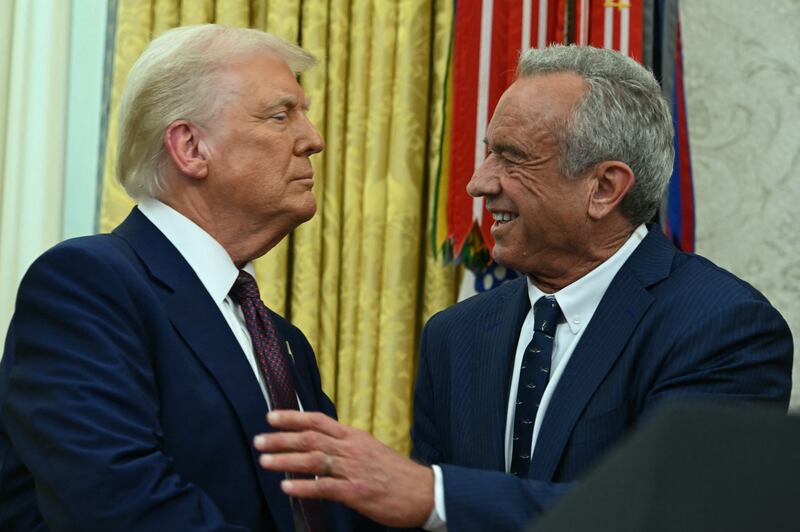 US Secretary of Health and Human Services Robert F. Kennedy Jr., shakes hands with US President Donald Trump after a swearing in ceremony in the Oval Office of the White House in Washington, DC, on February 13, 2025.