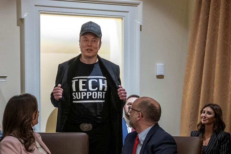 Leader of the Department of Government Efficiency Elon Musk wears a shirt that says "Tech Support" as he speaks during the first cabinet meeting of US President Donald Trump's second term in the Cabinet Room at the White House in Washington, DC, on February 26, 2025.