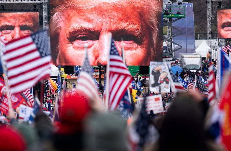 An image of Trump appears on video screens before his Jan. 6 speech.