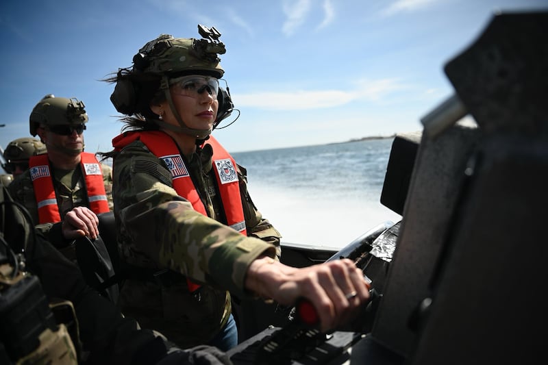 US Secretary of Homeland Security Kristi Noem (R) pilots a US Coast Guard Response Boat-Small (RBS) with the Maritime Security Response Team in San Diego, California, on March 16, 2025.