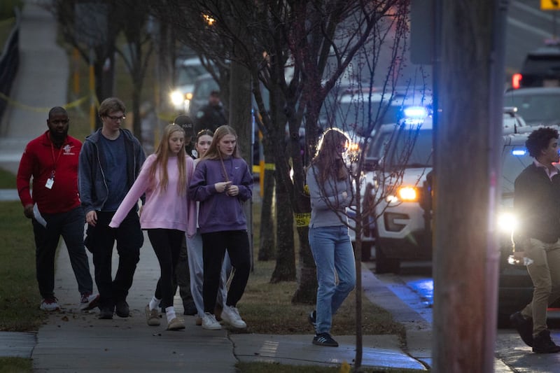 Students are escorted from a church next to the Abundant Life Christian School and loaded on busses to be taken to a reunification center.