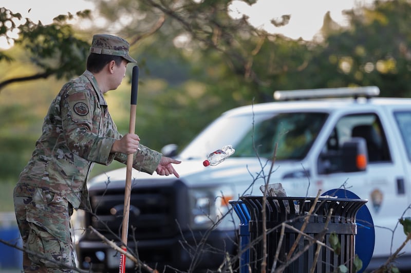 A National Guard troop discarding a bottle near the National Mall—tasks typically falling to the National Park Service are being picked up by the Guard after Trump slashed the federal workforce.