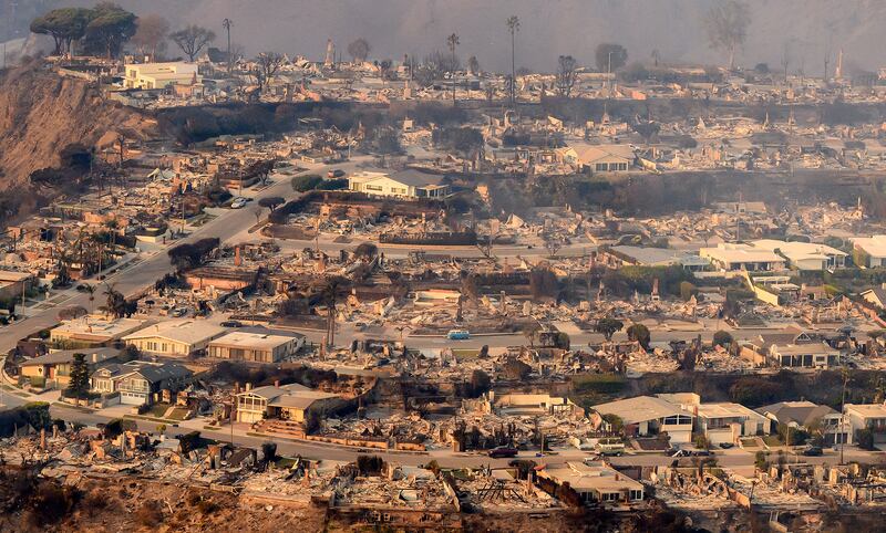 In this aerial view taken from a helicopter, burned homes are seen from above during the Palisades fire in Los Angeles county, California on Jan. 9, 2025. Swaths of the United States' second-largest city lay in ruins, with smoke blanketing the sky and an acrid smell pervading almost every building.