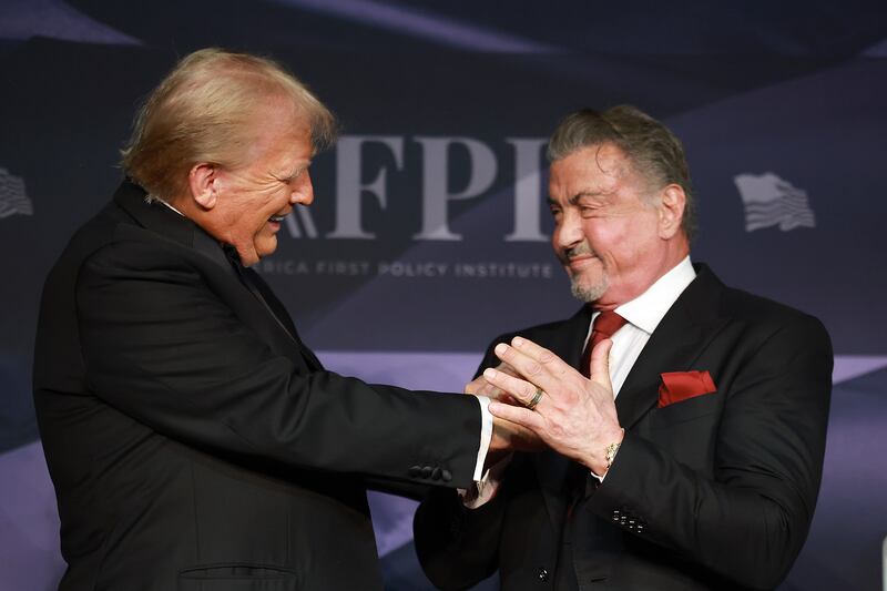 U.S. President-elect Donald Trump greets actor Sylvester Stallone onstage at the America First Policy Institute Gala held at Mar-a-Lago on November 14, 2024 in Palm Beach, Florida.