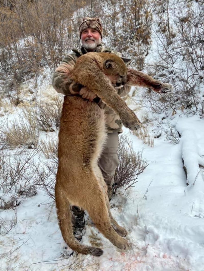 Asher Watkins posing with killed mountain lion.