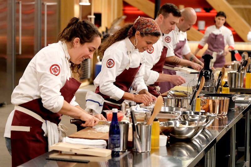 Paula Endara, Lana Lagomarsini, Vincenzo Loseto, and Henry Lu work in the kitchen during an episode of Top Chef.