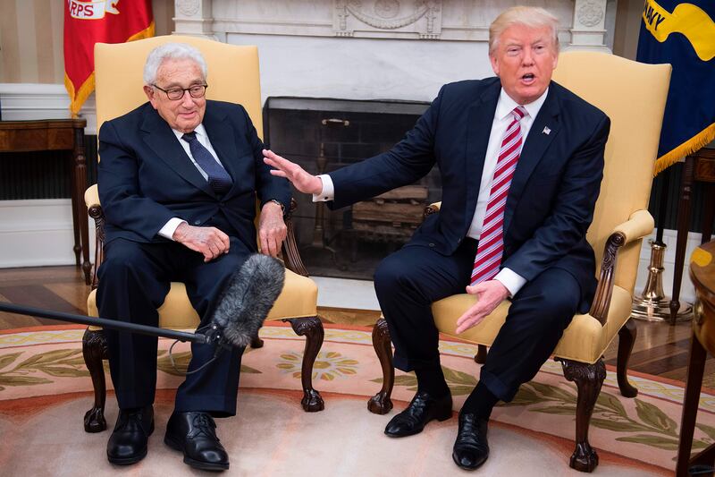President Donald Trump speaks with former Secretary of State Henry Kissinger during a meeting in the Oval Office, May 10, 2017.