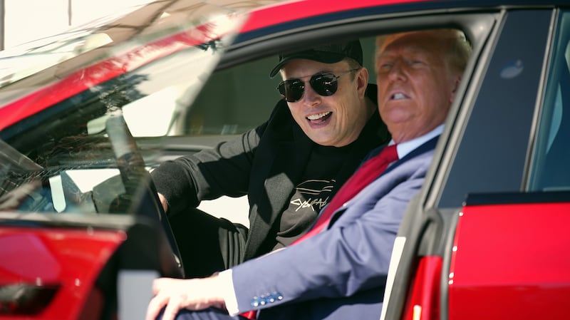 Trump and Musk sit in a Tesla during the stunt at the White House.