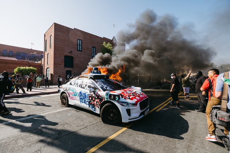 L.A. protesters lit up self-driving vehicles as they clashed with police over immigration raids.