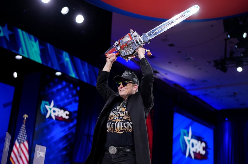 CEO of Tesla and SpaceX Elon Musk wields a chainsaw as he leaves the stage at the Conservative Political Action Conference (CPAC) at the Gaylord National Resort Hotel And Convention Center on February 20, 2025 in Oxon Hill, Maryland.