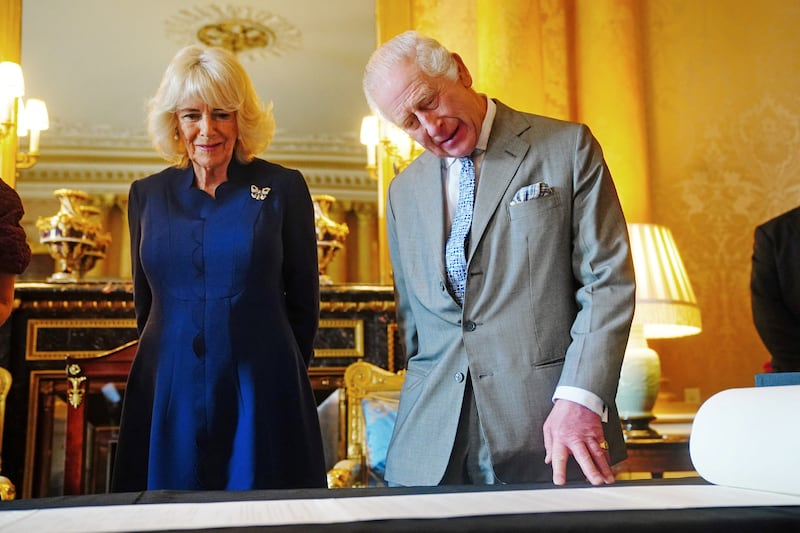King Charles and Queen Camilla are presented with the Coronation Roll, an official record of their Coronation, by the Clerk of the Crown in Chancery, at Buckingham Palace, central London, Britain May 1, 2024.