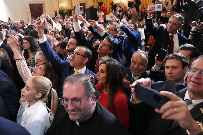 Reporters jostle to question U.S. President Donald Trump after a stunning national security breach Monday.