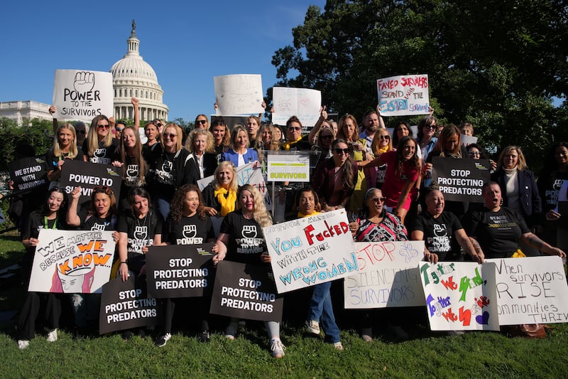 WASHINGTON, DC - SEPTEMBER 03: (EDITOR'S NOTE: Image contains profanity) Survivors of Jeffrey Epstein and their supporters pose for a photo during a rally in support of victims of the disgraced financier and sex trafficker outside the U.S. Capitol on September 03, 2025 in Washington, DC. Alleged victims of Epstein and other victims of sexual abuse are holding the rally amid a bipartisan Congressional effort to force the federal government to release all unclassified records from the cases of Epstein and his associate, Ghislaine Maxwell. (Photo by Andrew Harnik/Getty Images)